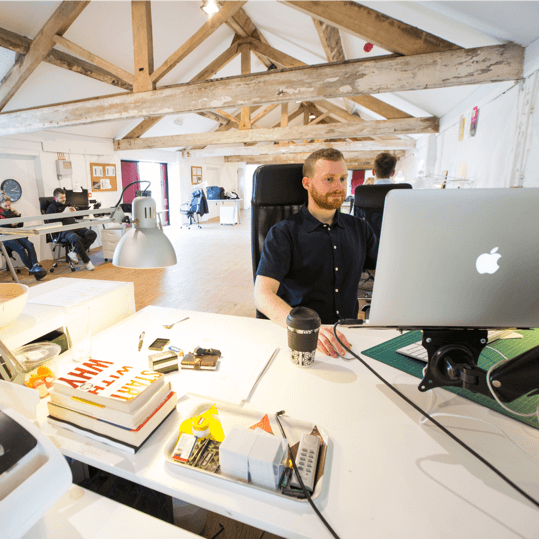 Team member working at a bright, creative workspace